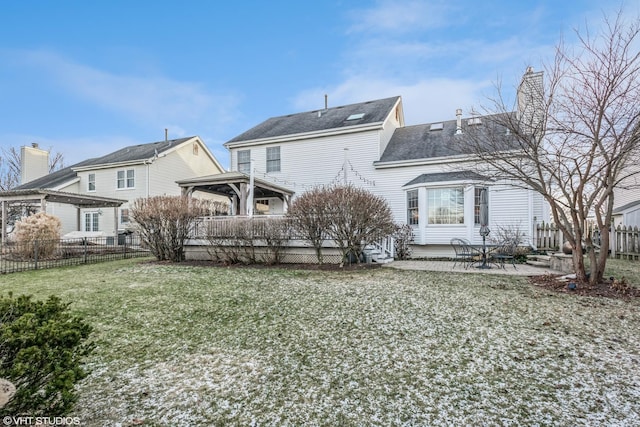 back of property featuring a patio area and a lawn