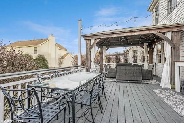 wooden deck featuring a gazebo and an outdoor hangout area