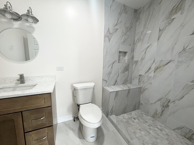 bathroom featuring toilet, vanity, and a tile shower