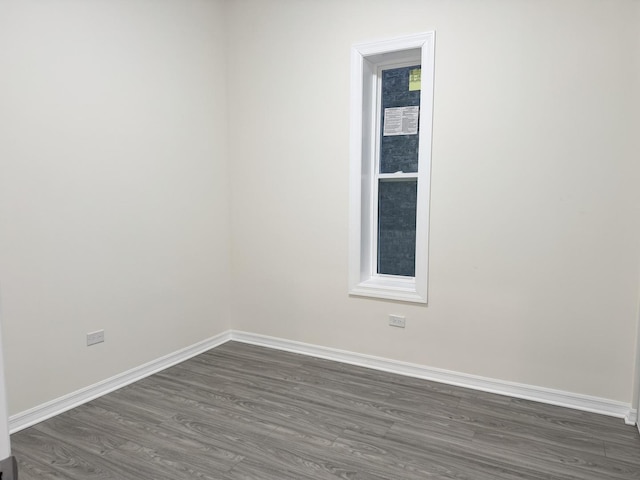 empty room with dark wood-type flooring