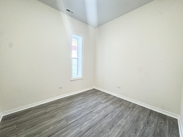 unfurnished room featuring dark hardwood / wood-style flooring