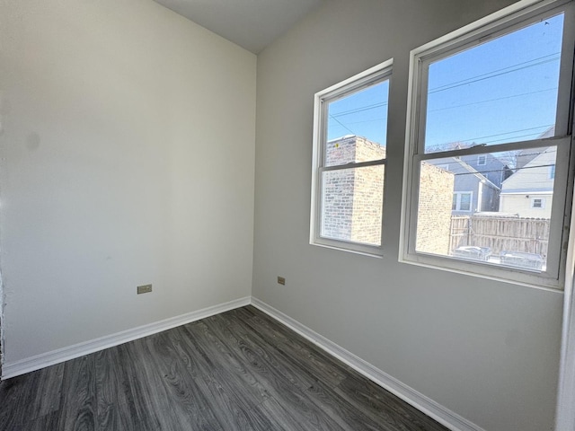 empty room with dark wood-type flooring