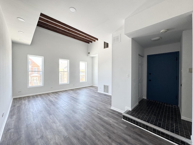 interior space featuring beam ceiling and dark hardwood / wood-style flooring