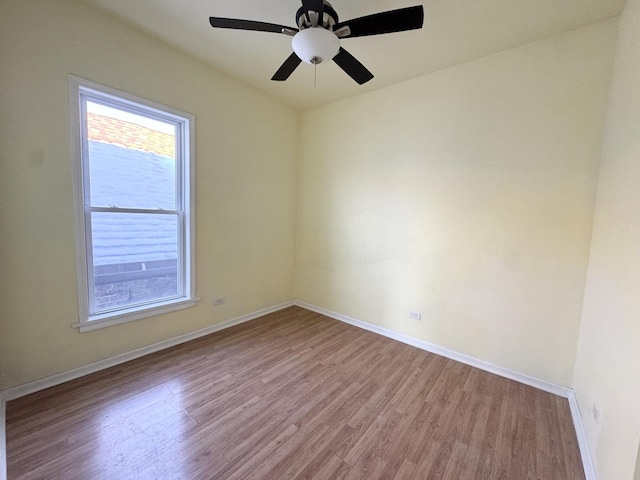 spare room with ceiling fan, a healthy amount of sunlight, and light hardwood / wood-style flooring