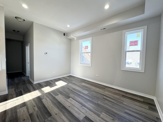 empty room featuring dark hardwood / wood-style flooring