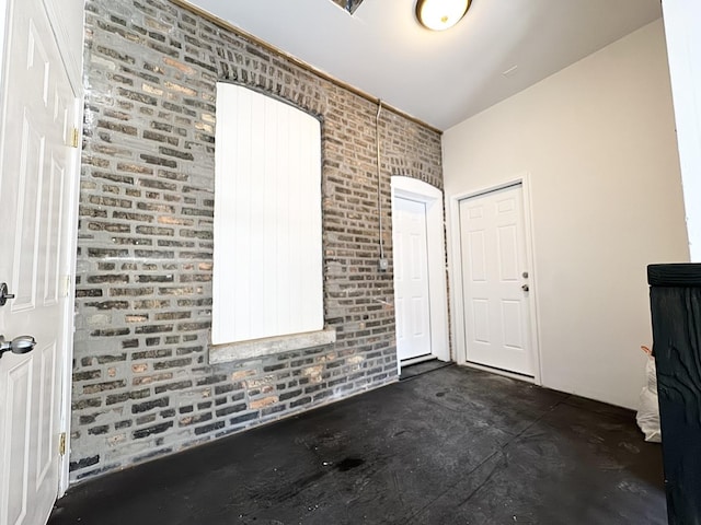 interior space featuring brick wall