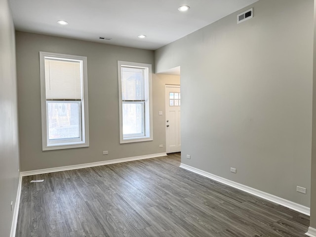 spare room with dark hardwood / wood-style flooring