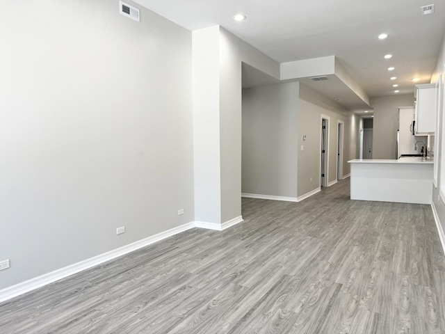 unfurnished living room featuring light wood-type flooring