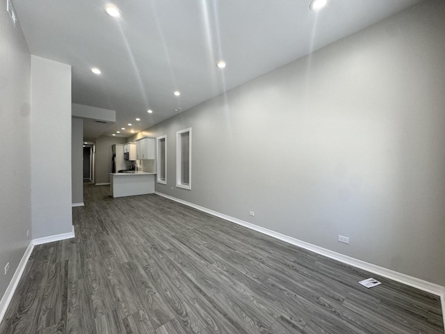 unfurnished living room featuring dark hardwood / wood-style flooring