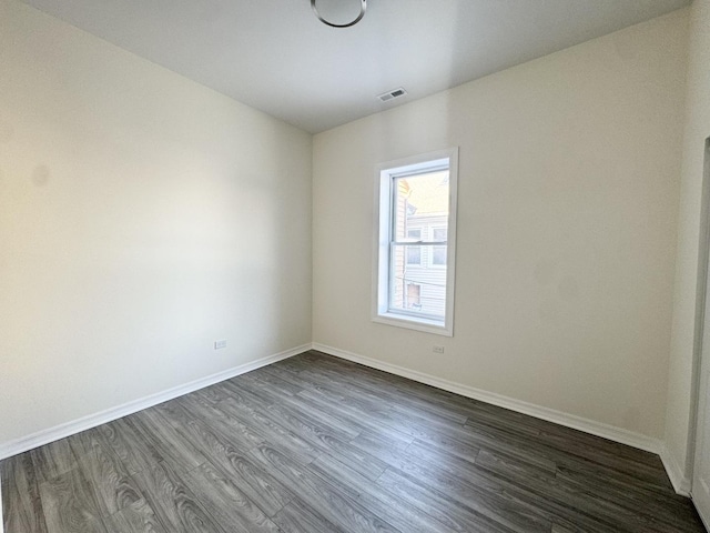 unfurnished room with dark hardwood / wood-style flooring