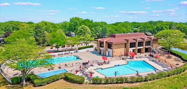 view of swimming pool with a patio and a water view