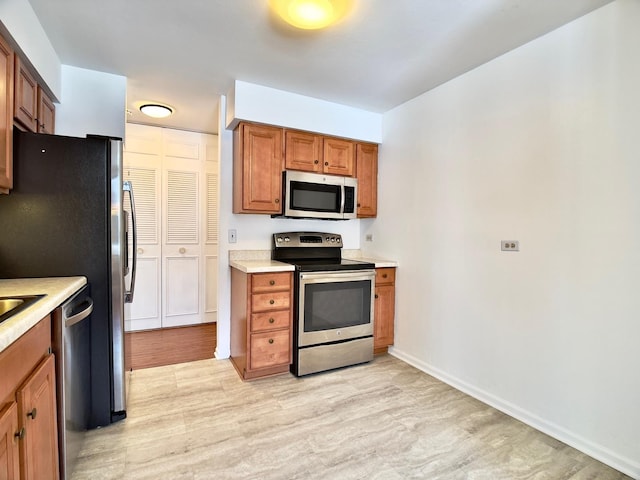 kitchen featuring stainless steel appliances and light wood-type flooring