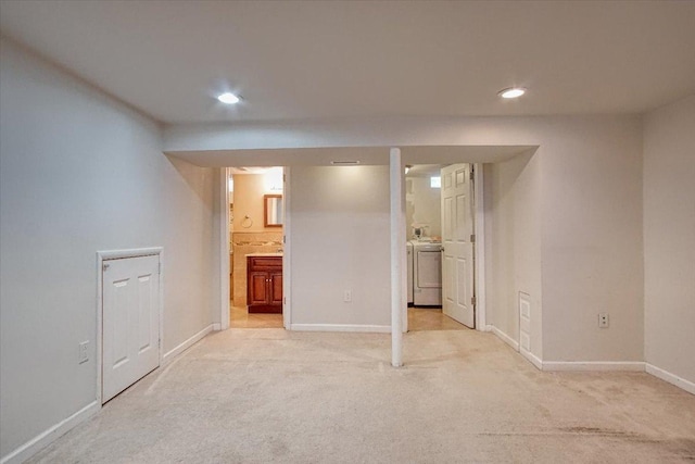 unfurnished bedroom featuring connected bathroom, washer / dryer, and light carpet