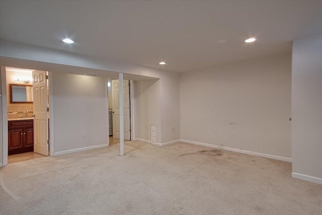 basement with light carpet and sink