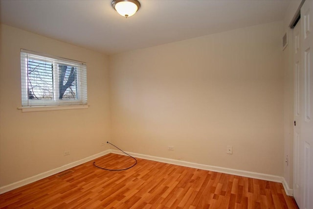 unfurnished room with light wood-type flooring