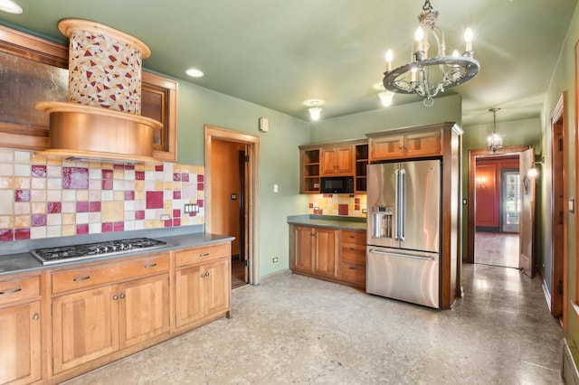 kitchen featuring decorative backsplash, decorative light fixtures, a chandelier, and appliances with stainless steel finishes