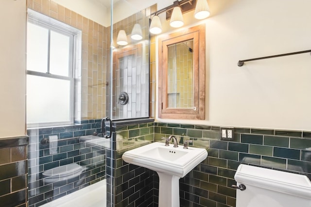 bathroom with tile walls and toilet