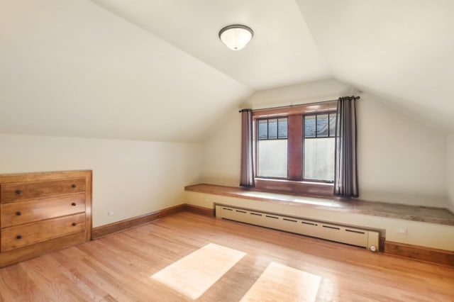 bonus room with lofted ceiling, light wood-type flooring, and baseboard heating