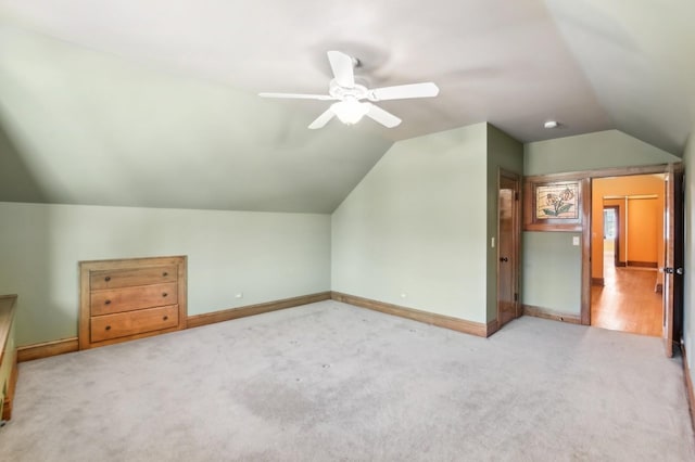 additional living space featuring carpet flooring and vaulted ceiling