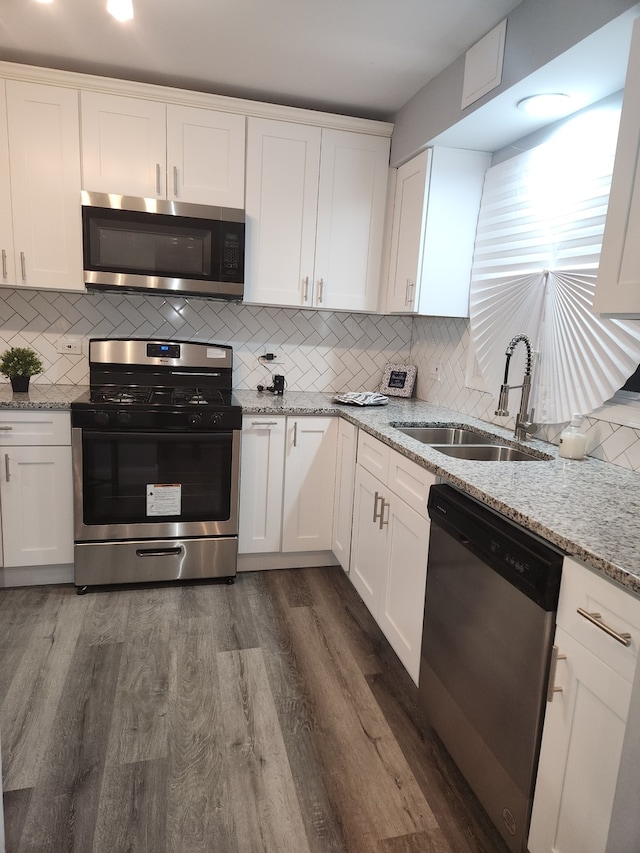 kitchen with white cabinets and appliances with stainless steel finishes