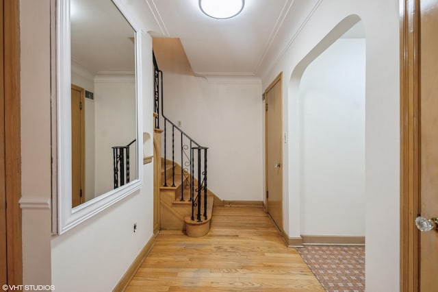 corridor with crown molding and light hardwood / wood-style flooring