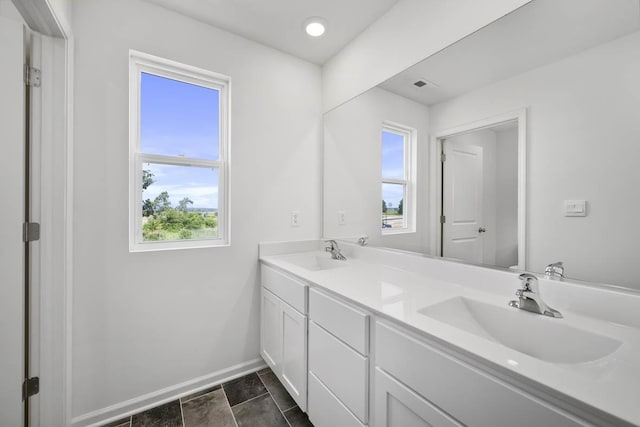 bathroom with tile patterned floors and vanity