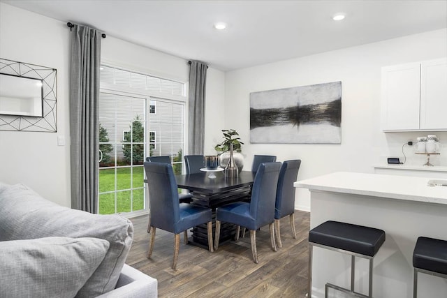 dining space with dark wood-type flooring and plenty of natural light