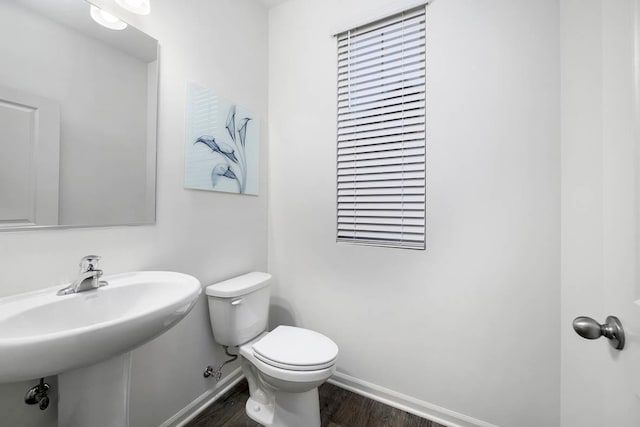 bathroom with toilet and wood-type flooring