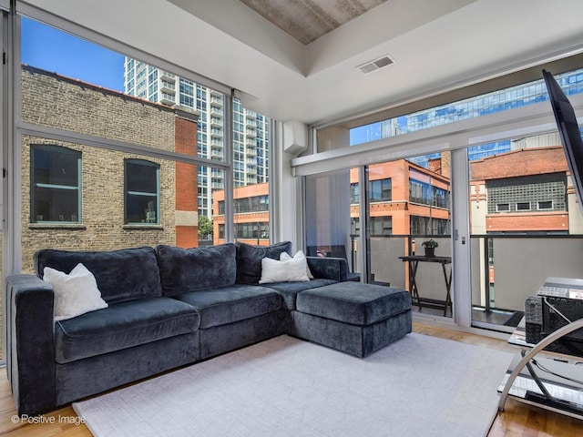 living room with a healthy amount of sunlight and hardwood / wood-style floors