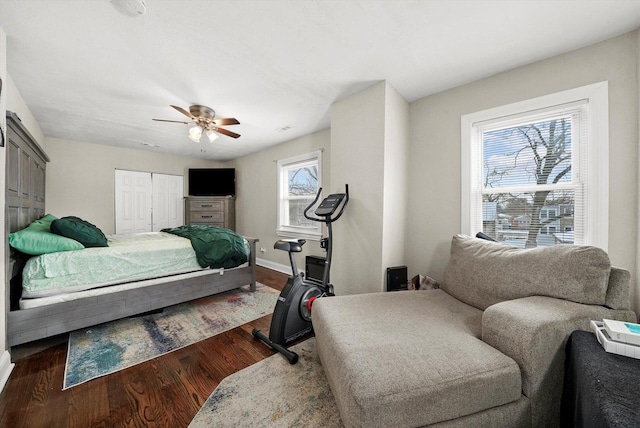 bedroom featuring ceiling fan, a closet, and dark hardwood / wood-style floors