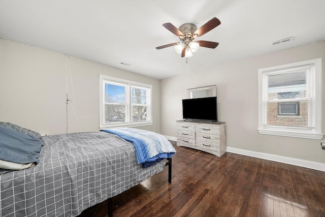 bedroom with ceiling fan and dark wood-type flooring