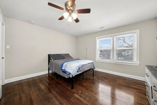 bedroom featuring ceiling fan and dark hardwood / wood-style floors