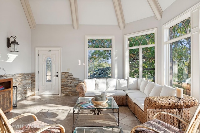 living area with beamed ceiling and high vaulted ceiling