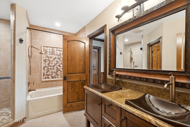 full bath with a tub, a tile shower, a sink, and tile patterned flooring