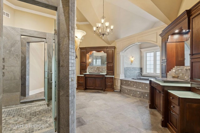 full bathroom with a bath, two vanities, a shower stall, backsplash, and a notable chandelier