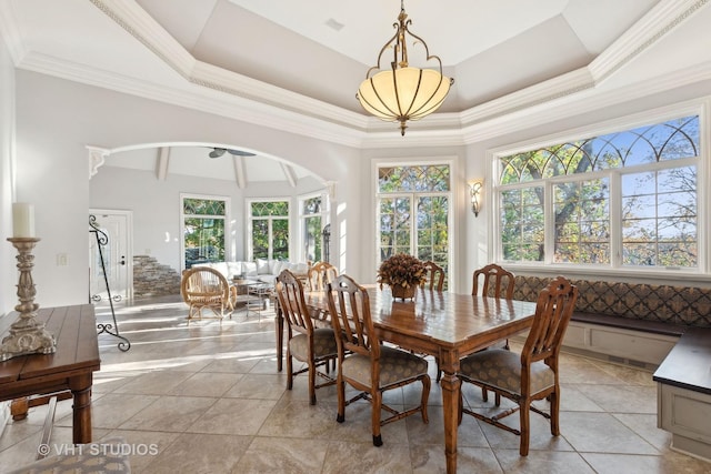 dining space featuring arched walkways, visible vents, light tile patterned flooring, and lofted ceiling