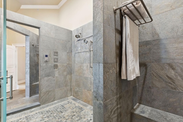 bathroom featuring crown molding and a walk in shower