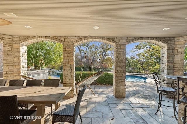 view of patio featuring outdoor dining area and a fenced in pool