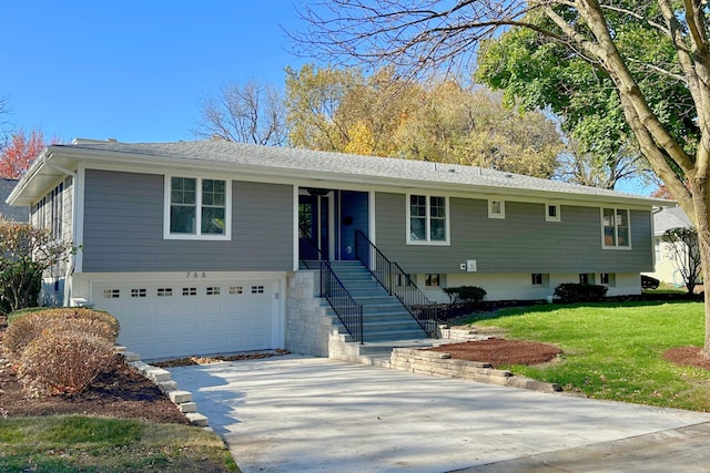 raised ranch featuring a front yard and a garage