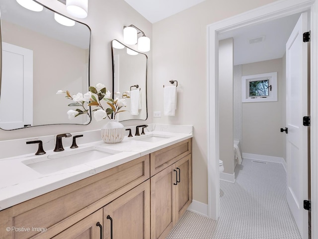 bathroom featuring toilet, vanity, and tile patterned floors