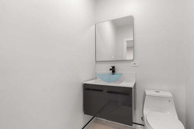 bathroom featuring toilet and vanity