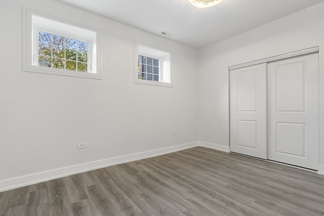 unfurnished bedroom featuring hardwood / wood-style flooring and a closet