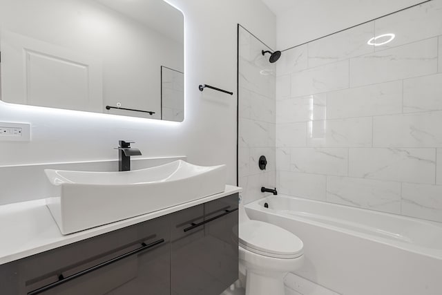 full bathroom featuring toilet, vanity, and tiled shower / bath combo