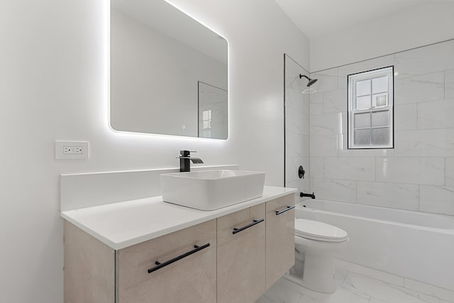 full bathroom featuring toilet, tiled shower / bath, and vanity