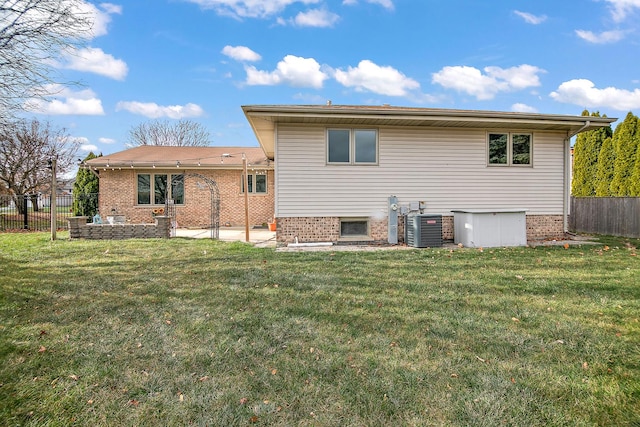 rear view of property with a yard and cooling unit