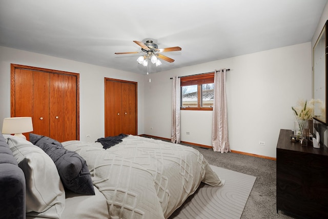 bedroom with multiple closets, ceiling fan, and carpet floors