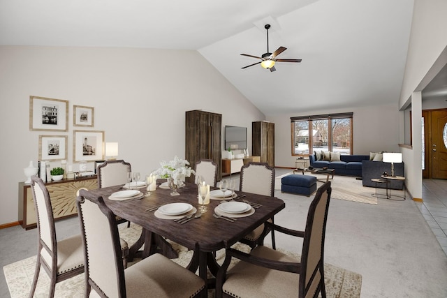 carpeted dining room featuring ceiling fan and high vaulted ceiling