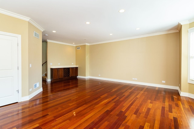 empty room featuring baseboards, stairs, visible vents, and wood finished floors