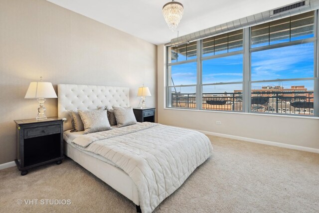 bedroom featuring an inviting chandelier and carpet