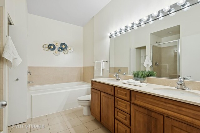 full bathroom featuring toilet, separate shower and tub, tile patterned floors, and vanity